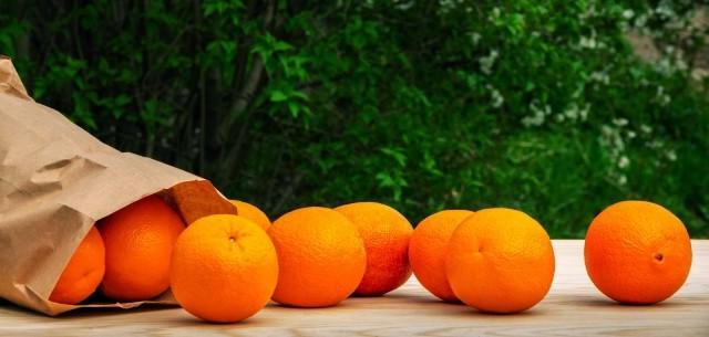 fruit arranged around a paper bag